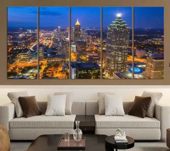 The room features three stunning pieces of the "Atlanta City Lights Cityscape View" wall art canvas prints, showcasing a lit-up city skyline adorned on the wall.