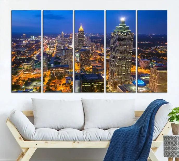 The room features three stunning pieces of the "Atlanta City Lights Cityscape View" wall art canvas prints, showcasing a lit-up city skyline adorned on the wall.