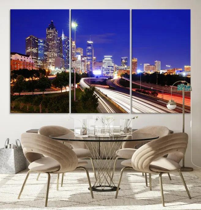 The living room features an Atlanta City Lights Night Blue Skyline canvas print on the wall. This museum-quality triptych showcases a highway and skyscrapers at night, comes with a UV-protective coating, and is ready to hang, adding both elegance and ease to your space.