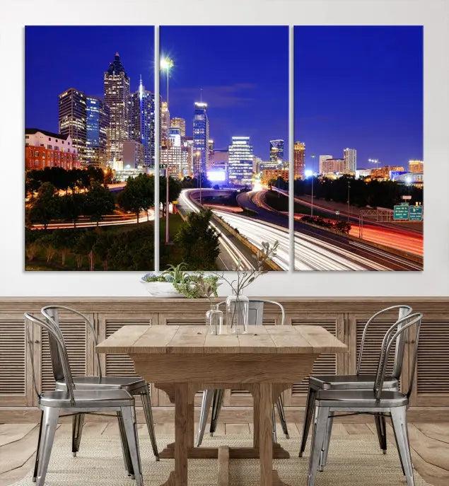 The living room features an Atlanta City Lights Night Blue Skyline canvas print on the wall. This museum-quality triptych showcases a highway and skyscrapers at night, comes with a UV-protective coating, and is ready to hang, adding both elegance and ease to your space.