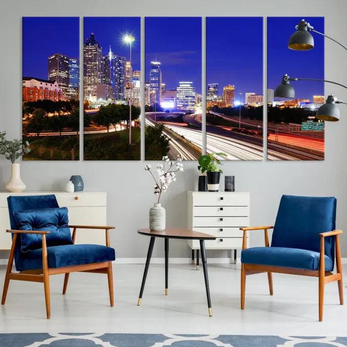 The living room features an Atlanta City Lights Night Blue Skyline canvas print on the wall. This museum-quality triptych showcases a highway and skyscrapers at night, comes with a UV-protective coating, and is ready to hang, adding both elegance and ease to your space.