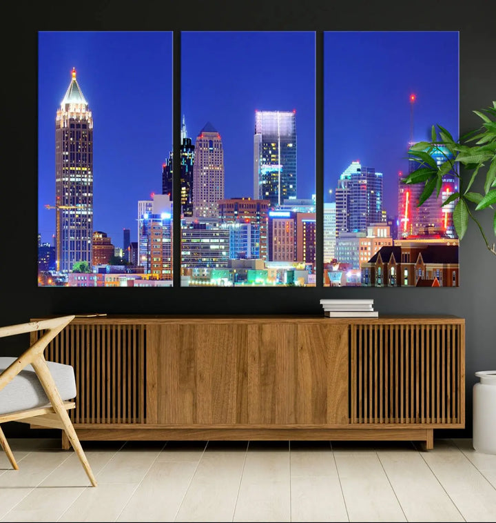 The modern living room is enhanced by the elegance of the "Atlanta City Lights Night Blue Skyline Cityscape Wall Art Canvas Print." This triptych, crafted on museum-quality canvas with a UV-protective coating, arrives ready to hang on the wall.