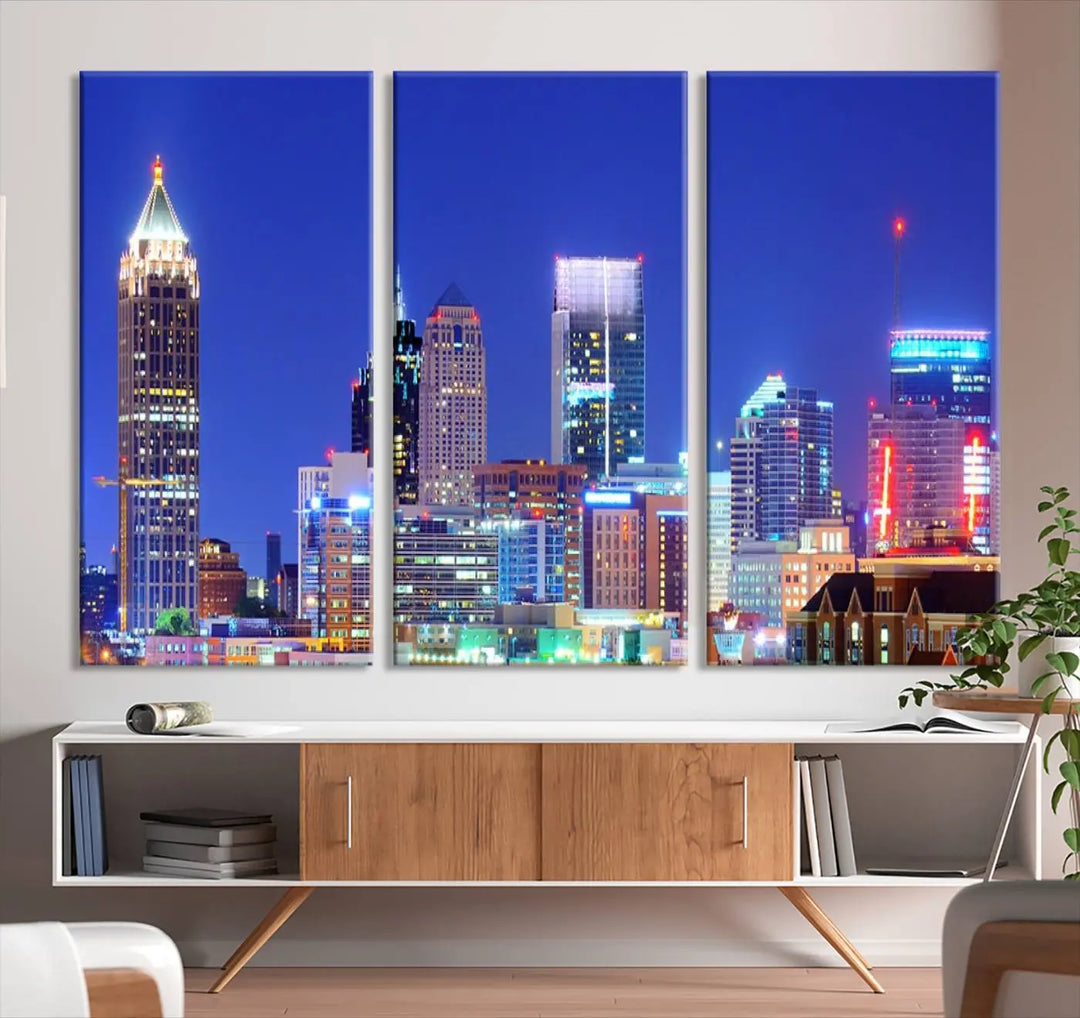 The modern living room is enhanced by the elegance of the "Atlanta City Lights Night Blue Skyline Cityscape Wall Art Canvas Print." This triptych, crafted on museum-quality canvas with a UV-protective coating, arrives ready to hang on the wall.