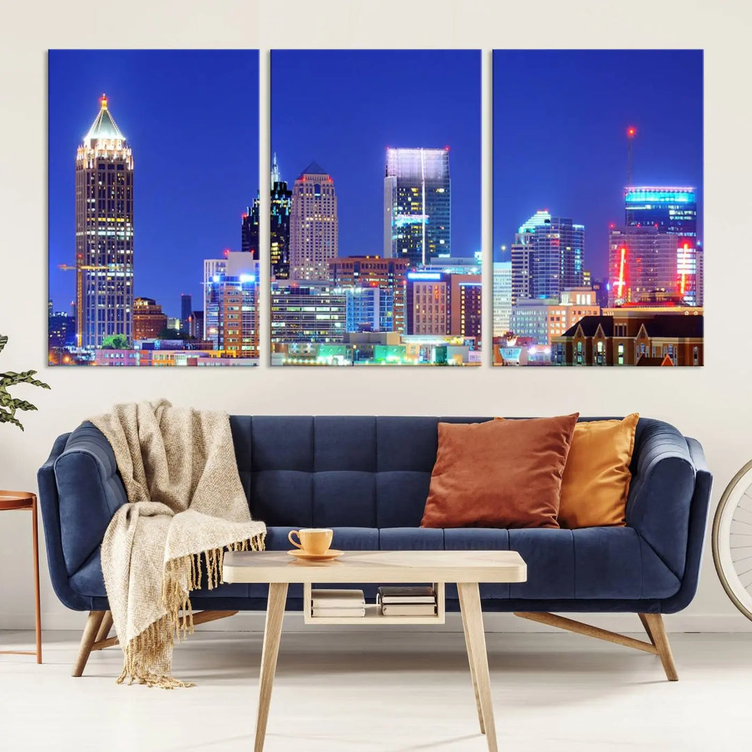 The modern living room is enhanced by the elegance of the "Atlanta City Lights Night Blue Skyline Cityscape Wall Art Canvas Print." This triptych, crafted on museum-quality canvas with a UV-protective coating, arrives ready to hang on the wall.