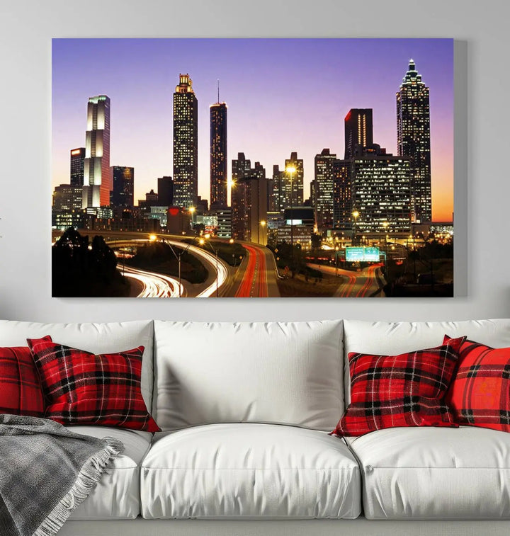 The Atlanta City Lights Sunset Purple Skyline Cityscape View wall art canvas print on the wall adds a touch of sophistication and transforms the space into an elegant sanctuary. The gallery-wrapped canvas print enhances the room's ambiance with its striking beauty.