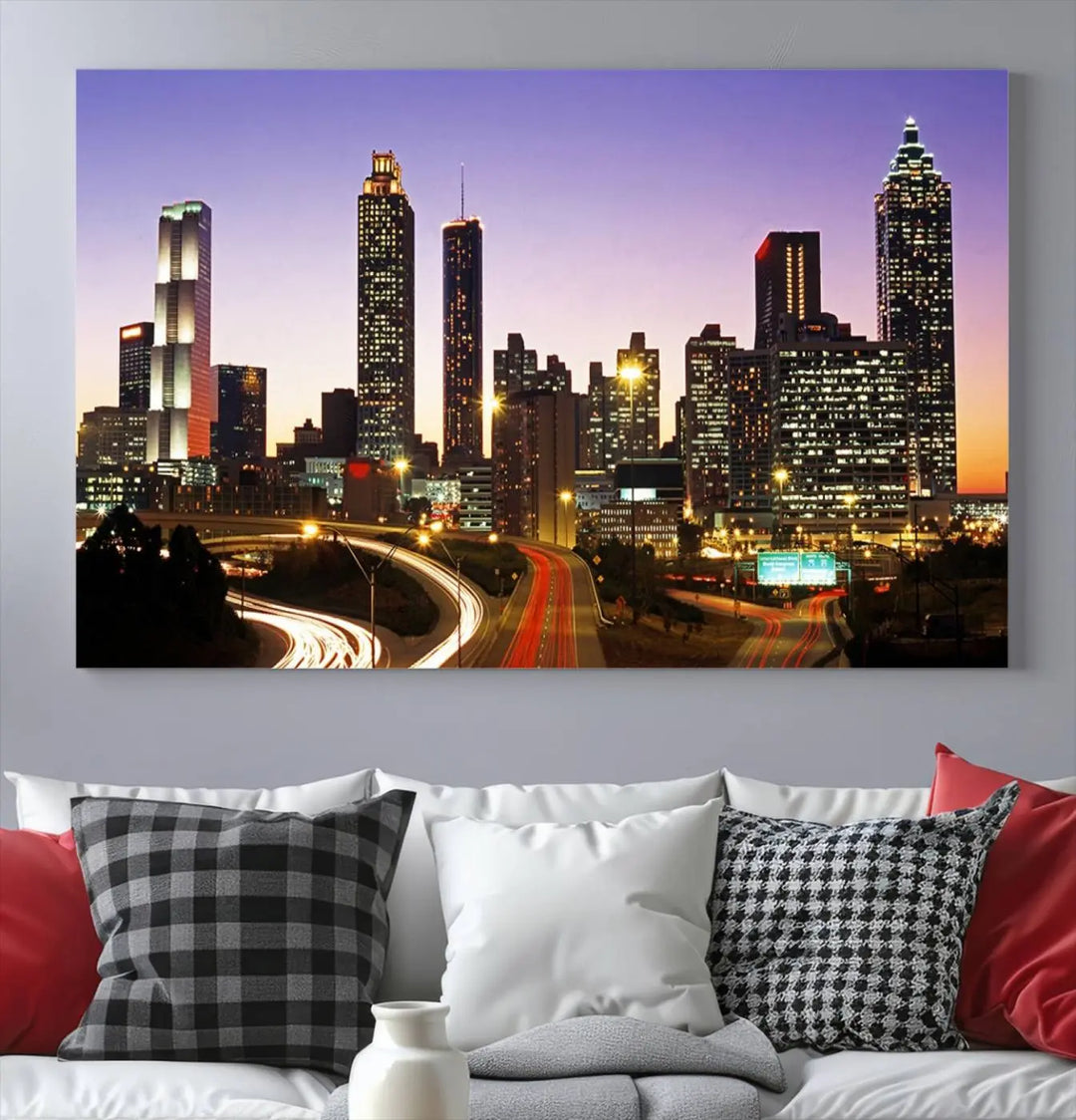 The Atlanta City Lights Sunset Purple Skyline Cityscape View wall art canvas print on the wall adds a touch of sophistication and transforms the space into an elegant sanctuary. The gallery-wrapped canvas print enhances the room's ambiance with its striking beauty.