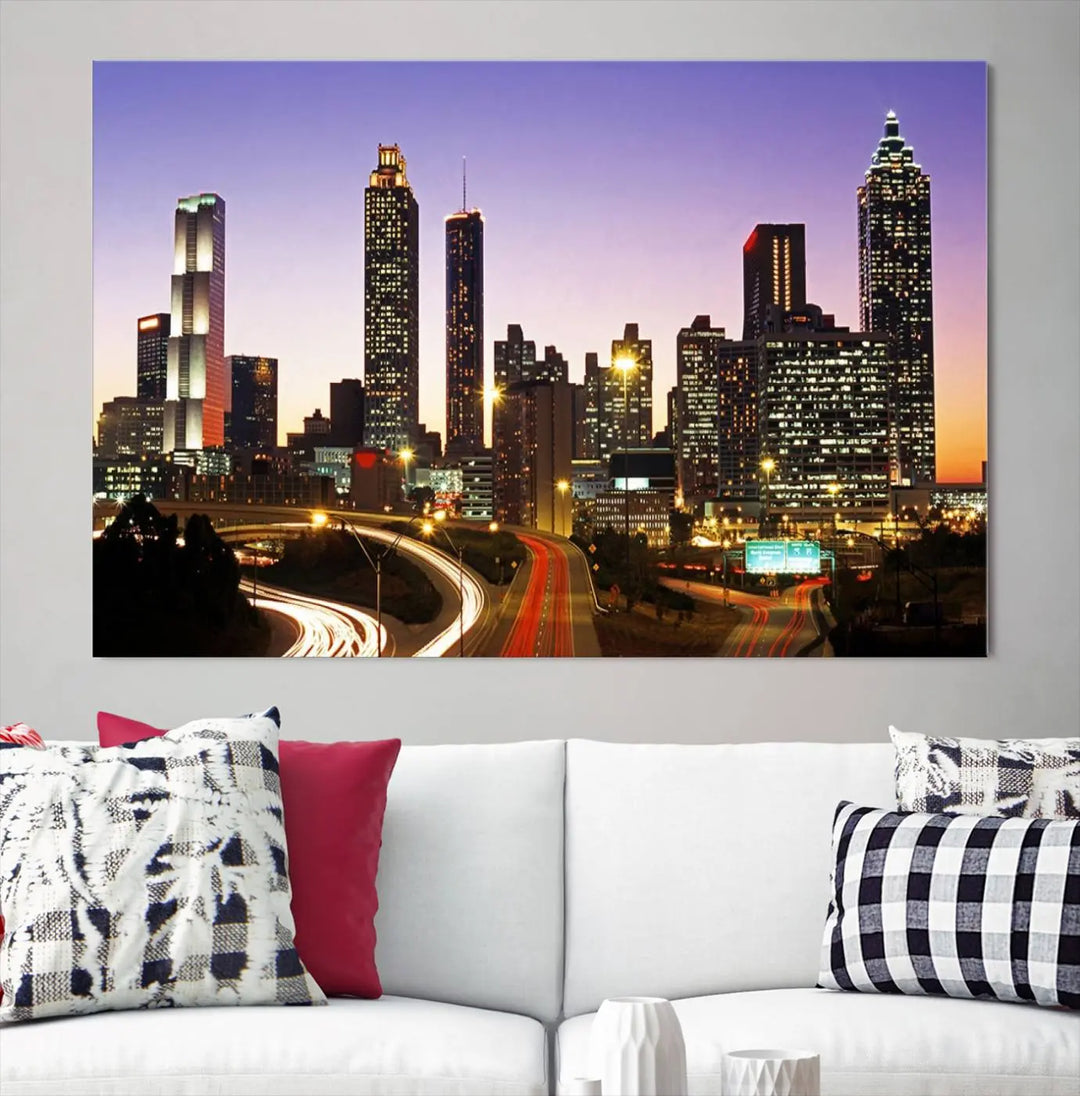 The Atlanta City Lights Sunset Purple Skyline Cityscape View wall art canvas print on the wall adds a touch of sophistication and transforms the space into an elegant sanctuary. The gallery-wrapped canvas print enhances the room's ambiance with its striking beauty.