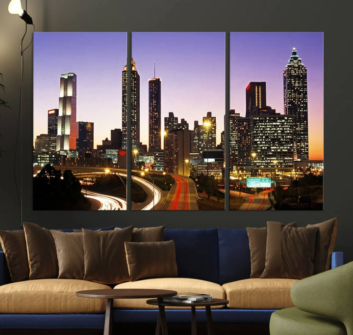 The Atlanta City Lights Sunset Purple Skyline Cityscape View wall art canvas print on the wall adds a touch of sophistication and transforms the space into an elegant sanctuary. The gallery-wrapped canvas print enhances the room's ambiance with its striking beauty.