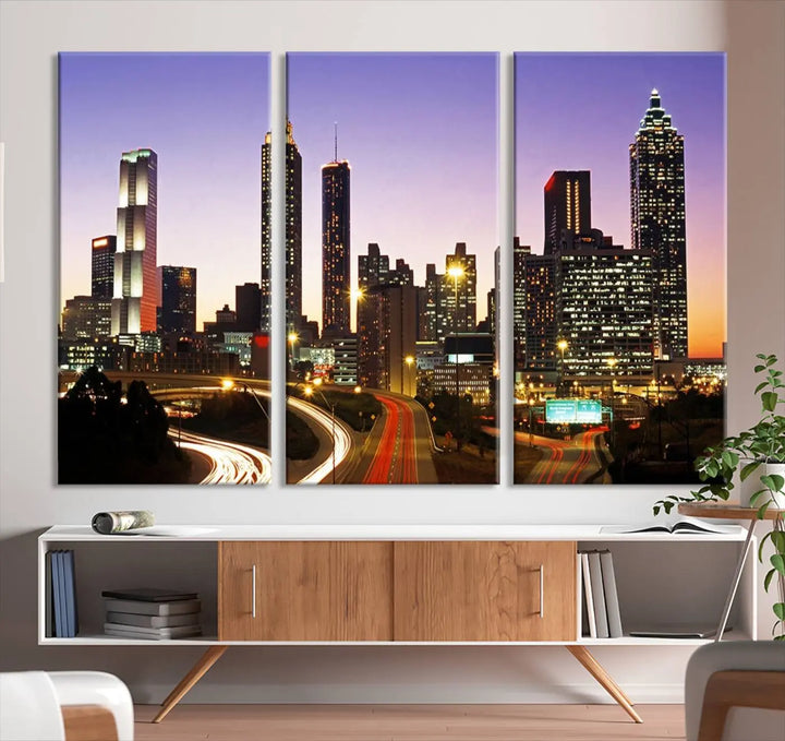 The Atlanta City Lights Sunset Purple Skyline Cityscape View wall art canvas print on the wall adds a touch of sophistication and transforms the space into an elegant sanctuary. The gallery-wrapped canvas print enhances the room's ambiance with its striking beauty.