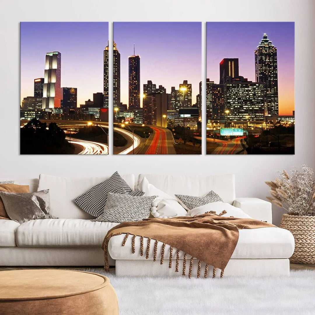 The Atlanta City Lights Sunset Purple Skyline Cityscape View wall art canvas print on the wall adds a touch of sophistication and transforms the space into an elegant sanctuary. The gallery-wrapped canvas print enhances the room's ambiance with its striking beauty.