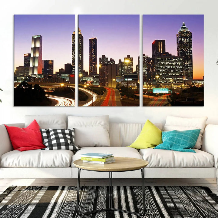 The Atlanta City Lights Sunset Purple Skyline Cityscape View wall art canvas print on the wall adds a touch of sophistication and transforms the space into an elegant sanctuary. The gallery-wrapped canvas print enhances the room's ambiance with its striking beauty.