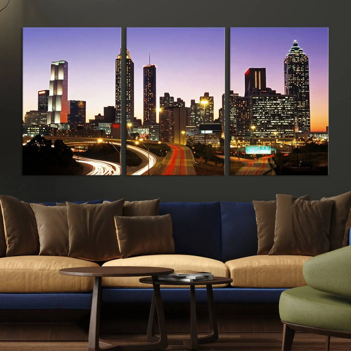 The Atlanta City Lights Sunset Purple Skyline Cityscape View wall art canvas print on the wall adds a touch of sophistication and transforms the space into an elegant sanctuary. The gallery-wrapped canvas print enhances the room's ambiance with its striking beauty.