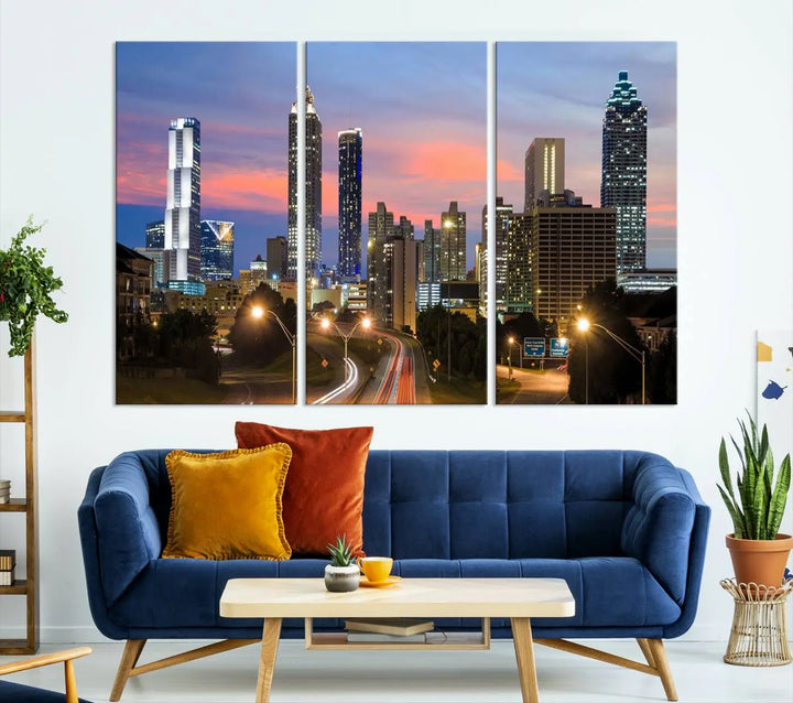 The Atlanta City Lights Sunset Skyline Cityscape View Wall Art Canvas Print is showcased in a modern living room. This artwork is gallery-wrapped on museum-quality canvas and features a UV-protective coating to maintain its vibrant colors.