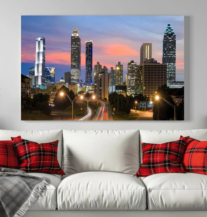 The Atlanta City Lights Sunset Skyline Cityscape View Wall Art Canvas Print is showcased in a modern living room. This artwork is gallery-wrapped on museum-quality canvas and features a UV-protective coating to maintain its vibrant colors.