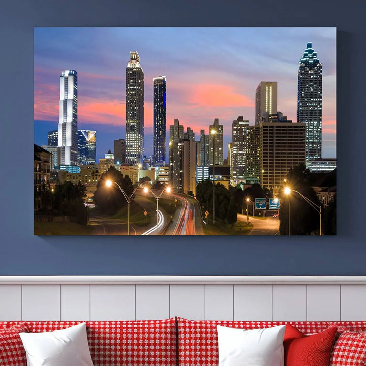 The Atlanta City Lights Sunset Skyline Cityscape View Wall Art Canvas Print is showcased in a modern living room. This artwork is gallery-wrapped on museum-quality canvas and features a UV-protective coating to maintain its vibrant colors.