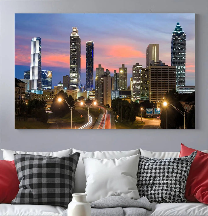 The Atlanta City Lights Sunset Skyline Cityscape View Wall Art Canvas Print is showcased in a modern living room. This artwork is gallery-wrapped on museum-quality canvas and features a UV-protective coating to maintain its vibrant colors.