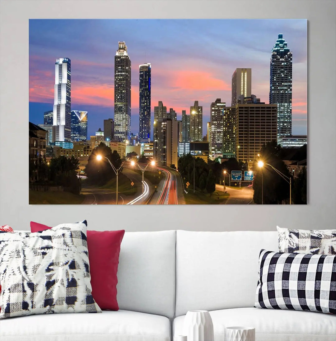 The Atlanta City Lights Sunset Skyline Cityscape View Wall Art Canvas Print is showcased in a modern living room. This artwork is gallery-wrapped on museum-quality canvas and features a UV-protective coating to maintain its vibrant colors.