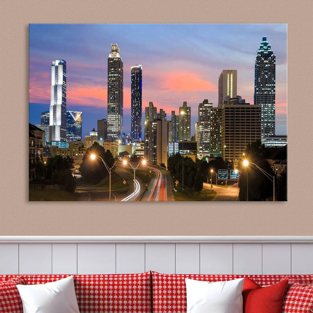 The Atlanta City Lights Sunset Skyline Cityscape View Wall Art Canvas Print is showcased in a modern living room. This artwork is gallery-wrapped on museum-quality canvas and features a UV-protective coating to maintain its vibrant colors.