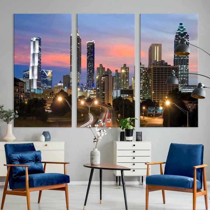 The Atlanta City Lights Sunset Skyline Cityscape View Wall Art Canvas Print is showcased in a modern living room. This artwork is gallery-wrapped on museum-quality canvas and features a UV-protective coating to maintain its vibrant colors.