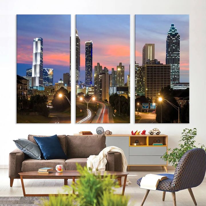 The Atlanta City Lights Sunset Skyline Cityscape View Wall Art Canvas Print is showcased in a modern living room. This artwork is gallery-wrapped on museum-quality canvas and features a UV-protective coating to maintain its vibrant colors.