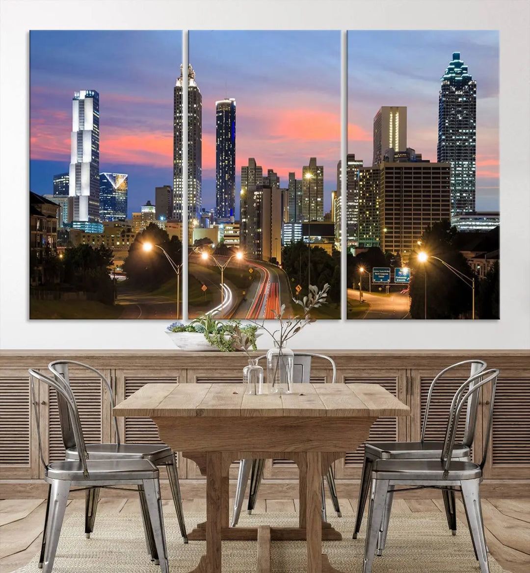 The Atlanta City Lights Sunset Skyline Cityscape View Wall Art Canvas Print is showcased in a modern living room. This artwork is gallery-wrapped on museum-quality canvas and features a UV-protective coating to maintain its vibrant colors.