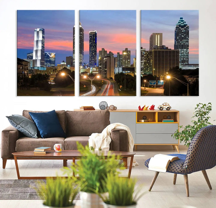 The Atlanta City Lights Sunset Skyline Cityscape View Wall Art Canvas Print is showcased in a modern living room. This artwork is gallery-wrapped on museum-quality canvas and features a UV-protective coating to maintain its vibrant colors.