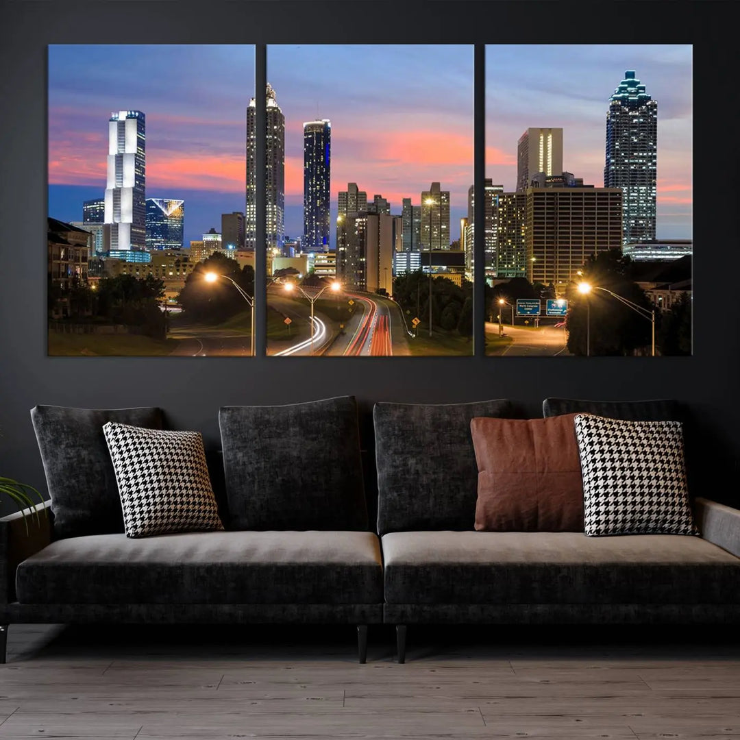 The Atlanta City Lights Sunset Skyline Cityscape View Wall Art Canvas Print is showcased in a modern living room. This artwork is gallery-wrapped on museum-quality canvas and features a UV-protective coating to maintain its vibrant colors.