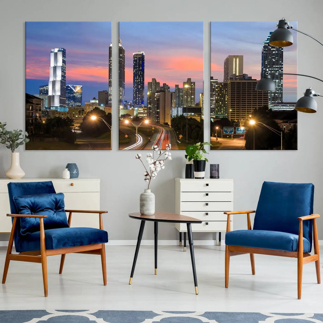 The Atlanta City Lights Sunset Skyline Cityscape View Wall Art Canvas Print is showcased in a modern living room. This artwork is gallery-wrapped on museum-quality canvas and features a UV-protective coating to maintain its vibrant colors.