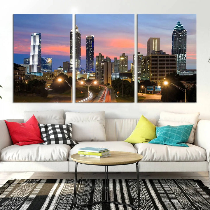 The Atlanta City Lights Sunset Skyline Cityscape View Wall Art Canvas Print is showcased in a modern living room. This artwork is gallery-wrapped on museum-quality canvas and features a UV-protective coating to maintain its vibrant colors.