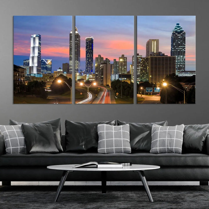 The Atlanta City Lights Sunset Skyline Cityscape View Wall Art Canvas Print is showcased in a modern living room. This artwork is gallery-wrapped on museum-quality canvas and features a UV-protective coating to maintain its vibrant colors.