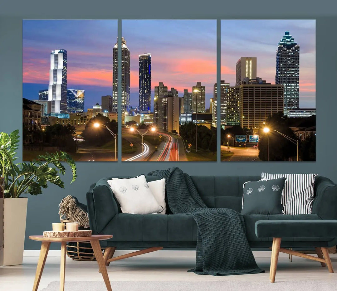 The Atlanta City Lights Sunset Skyline Cityscape View Wall Art Canvas Print is showcased in a modern living room. This artwork is gallery-wrapped on museum-quality canvas and features a UV-protective coating to maintain its vibrant colors.