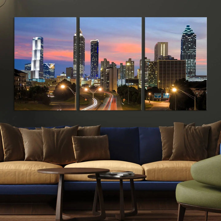 The Atlanta City Lights Sunset Skyline Cityscape View Wall Art Canvas Print is showcased in a modern living room. This artwork is gallery-wrapped on museum-quality canvas and features a UV-protective coating to maintain its vibrant colors.