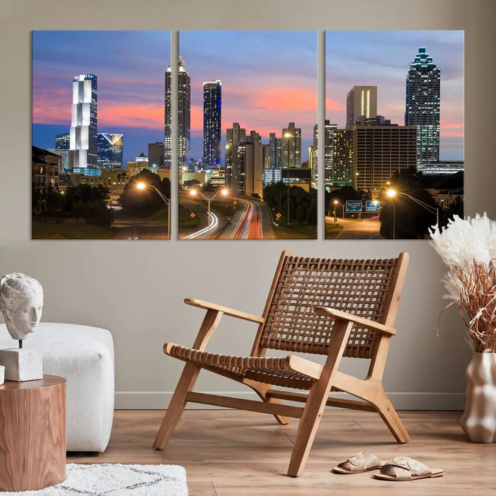 The Atlanta City Lights Sunset Skyline Cityscape View Wall Art Canvas Print is showcased in a modern living room. This artwork is gallery-wrapped on museum-quality canvas and features a UV-protective coating to maintain its vibrant colors.