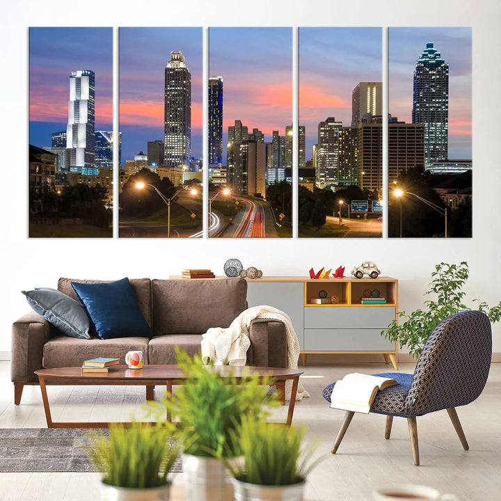 The Atlanta City Lights Sunset Skyline Cityscape View Wall Art Canvas Print is showcased in a modern living room. This artwork is gallery-wrapped on museum-quality canvas and features a UV-protective coating to maintain its vibrant colors.