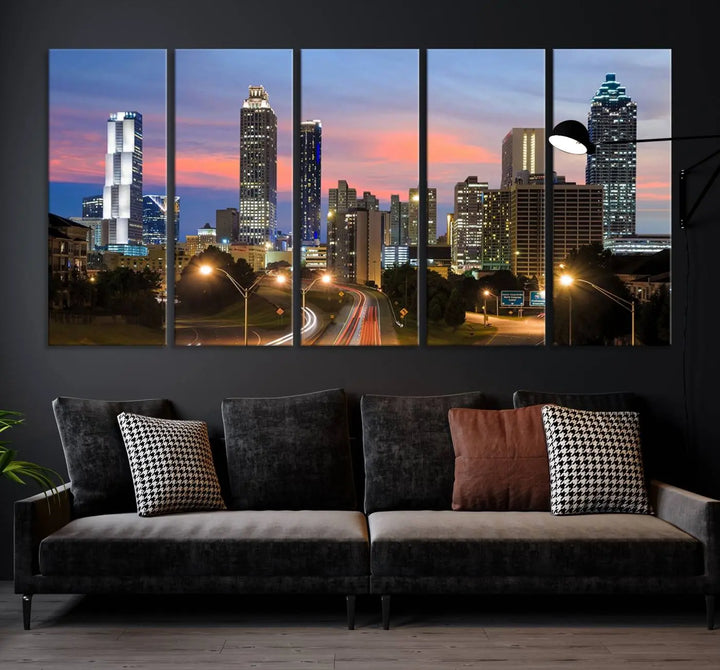 The Atlanta City Lights Sunset Skyline Cityscape View Wall Art Canvas Print is showcased in a modern living room. This artwork is gallery-wrapped on museum-quality canvas and features a UV-protective coating to maintain its vibrant colors.