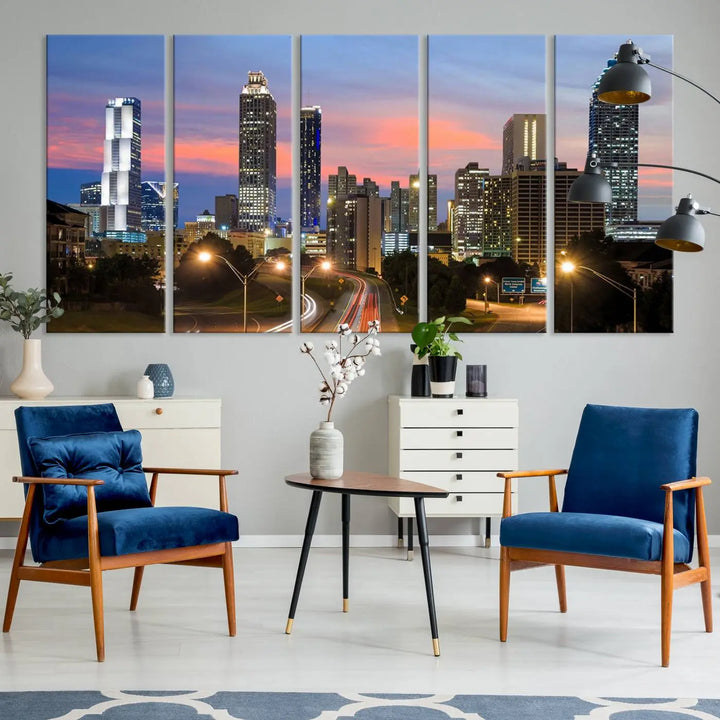 The Atlanta City Lights Sunset Skyline Cityscape View Wall Art Canvas Print is showcased in a modern living room. This artwork is gallery-wrapped on museum-quality canvas and features a UV-protective coating to maintain its vibrant colors.