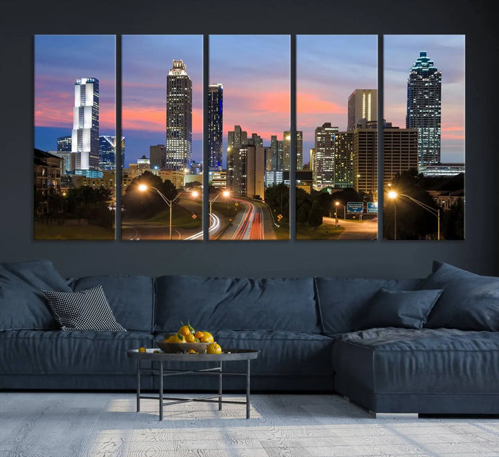 The Atlanta City Lights Sunset Skyline Cityscape View Wall Art Canvas Print is showcased in a modern living room. This artwork is gallery-wrapped on museum-quality canvas and features a UV-protective coating to maintain its vibrant colors.