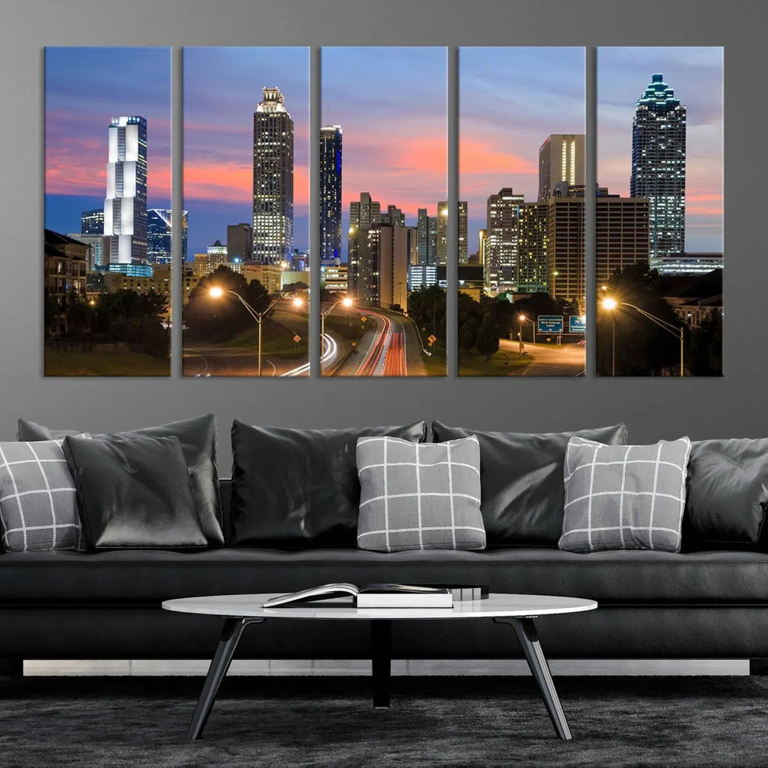 The Atlanta City Lights Sunset Skyline Cityscape View Wall Art Canvas Print is showcased in a modern living room. This artwork is gallery-wrapped on museum-quality canvas and features a UV-protective coating to maintain its vibrant colors.