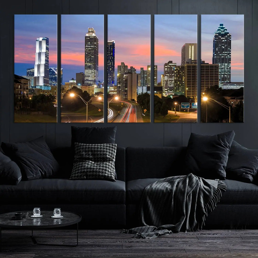 The Atlanta City Lights Sunset Skyline Cityscape View Wall Art Canvas Print is showcased in a modern living room. This artwork is gallery-wrapped on museum-quality canvas and features a UV-protective coating to maintain its vibrant colors.