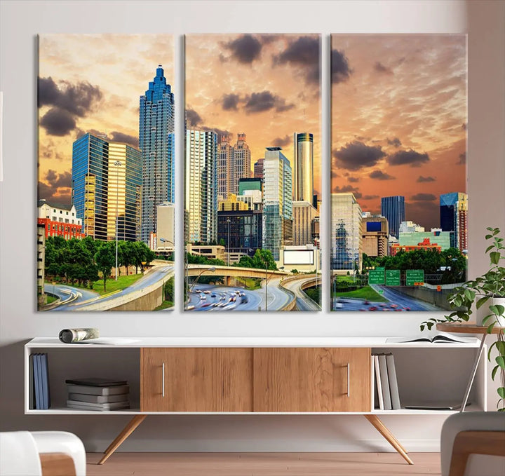 The wall is adorned with the Atlanta City Lights Sunset Skyline Cityscape View Wall Art Canvas Print, elegantly gallery wrapped and showcasing a skyline beneath a partly cloudy sky. This piece is created on museum-quality canvas and features a UV-protective coating to ensure lasting vibrancy.