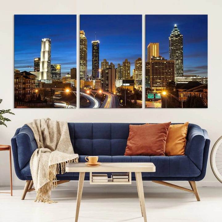 A modern living room is enhanced by the "Atlanta Cityscape View Wall Art Canvas Print" displayed as a triptych on museum-quality canvas. The hand-assembled framed art adds sophistication, crafting an inviting atmosphere. Complete your stylish space effortlessly with free shipping.