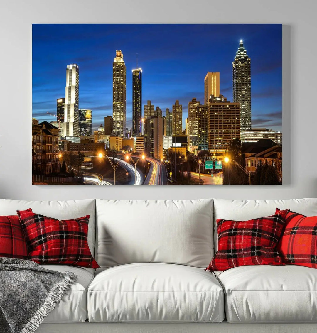 A modern living room is enhanced by the "Atlanta Cityscape View Wall Art Canvas Print" displayed as a triptych on museum-quality canvas. The hand-assembled framed art adds sophistication, crafting an inviting atmosphere. Complete your stylish space effortlessly with free shipping.