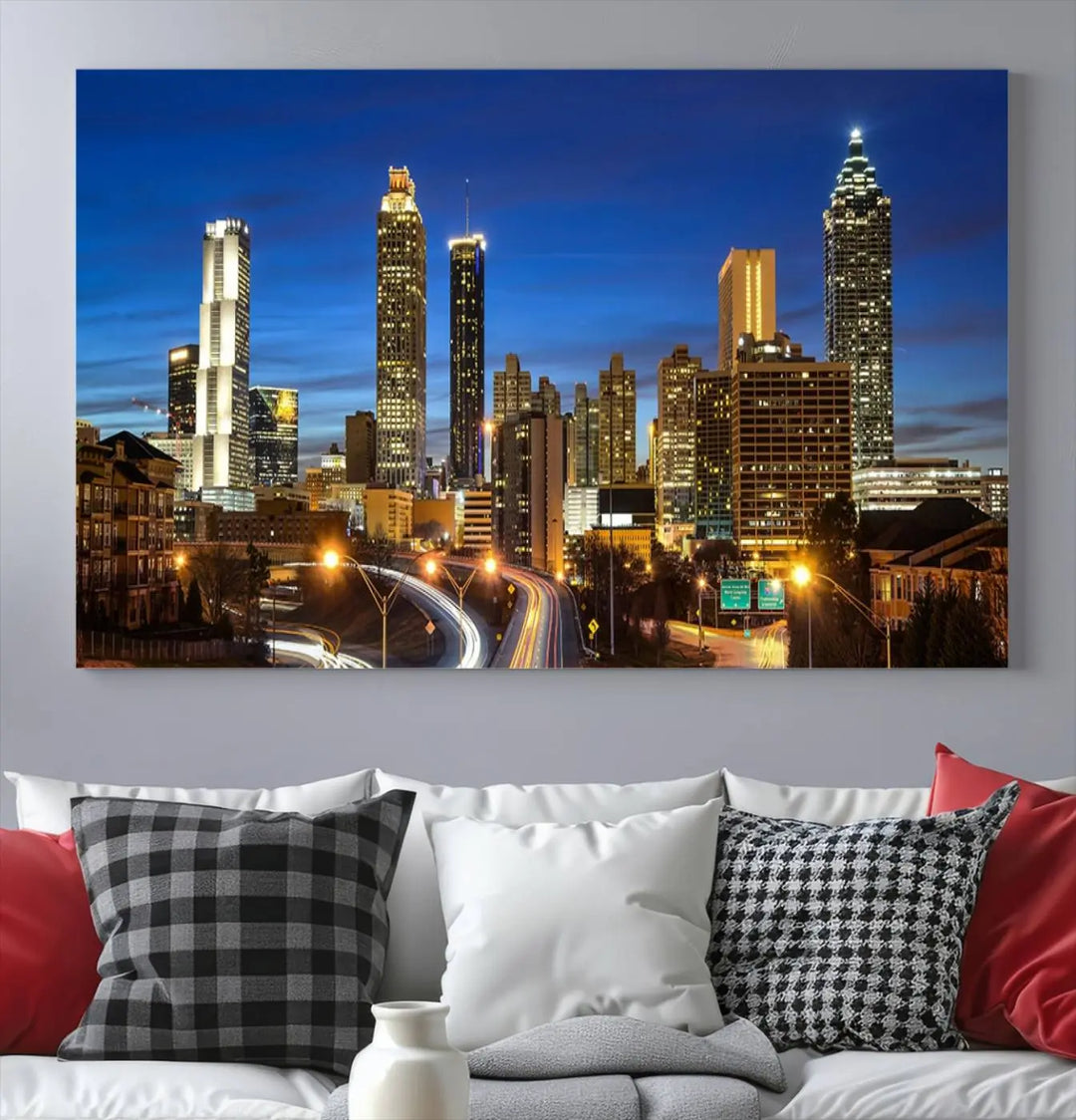 A modern living room is enhanced by the "Atlanta Cityscape View Wall Art Canvas Print" displayed as a triptych on museum-quality canvas. The hand-assembled framed art adds sophistication, crafting an inviting atmosphere. Complete your stylish space effortlessly with free shipping.