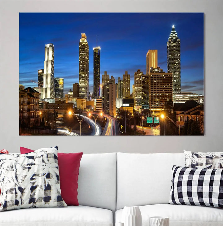 A modern living room is enhanced by the "Atlanta Cityscape View Wall Art Canvas Print" displayed as a triptych on museum-quality canvas. The hand-assembled framed art adds sophistication, crafting an inviting atmosphere. Complete your stylish space effortlessly with free shipping.