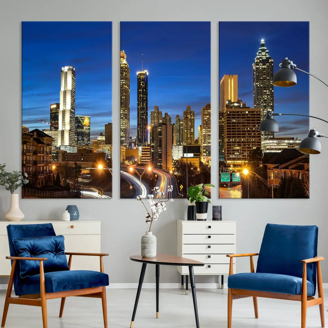 A modern living room is enhanced by the "Atlanta Cityscape View Wall Art Canvas Print" displayed as a triptych on museum-quality canvas. The hand-assembled framed art adds sophistication, crafting an inviting atmosphere. Complete your stylish space effortlessly with free shipping.