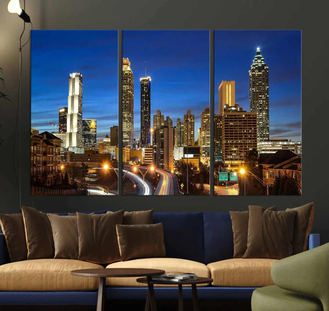 A modern living room is enhanced by the "Atlanta Cityscape View Wall Art Canvas Print" displayed as a triptych on museum-quality canvas. The hand-assembled framed art adds sophistication, crafting an inviting atmosphere. Complete your stylish space effortlessly with free shipping.