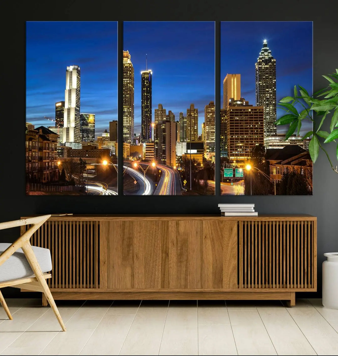 A modern living room is enhanced by the "Atlanta Cityscape View Wall Art Canvas Print" displayed as a triptych on museum-quality canvas. The hand-assembled framed art adds sophistication, crafting an inviting atmosphere. Complete your stylish space effortlessly with free shipping.