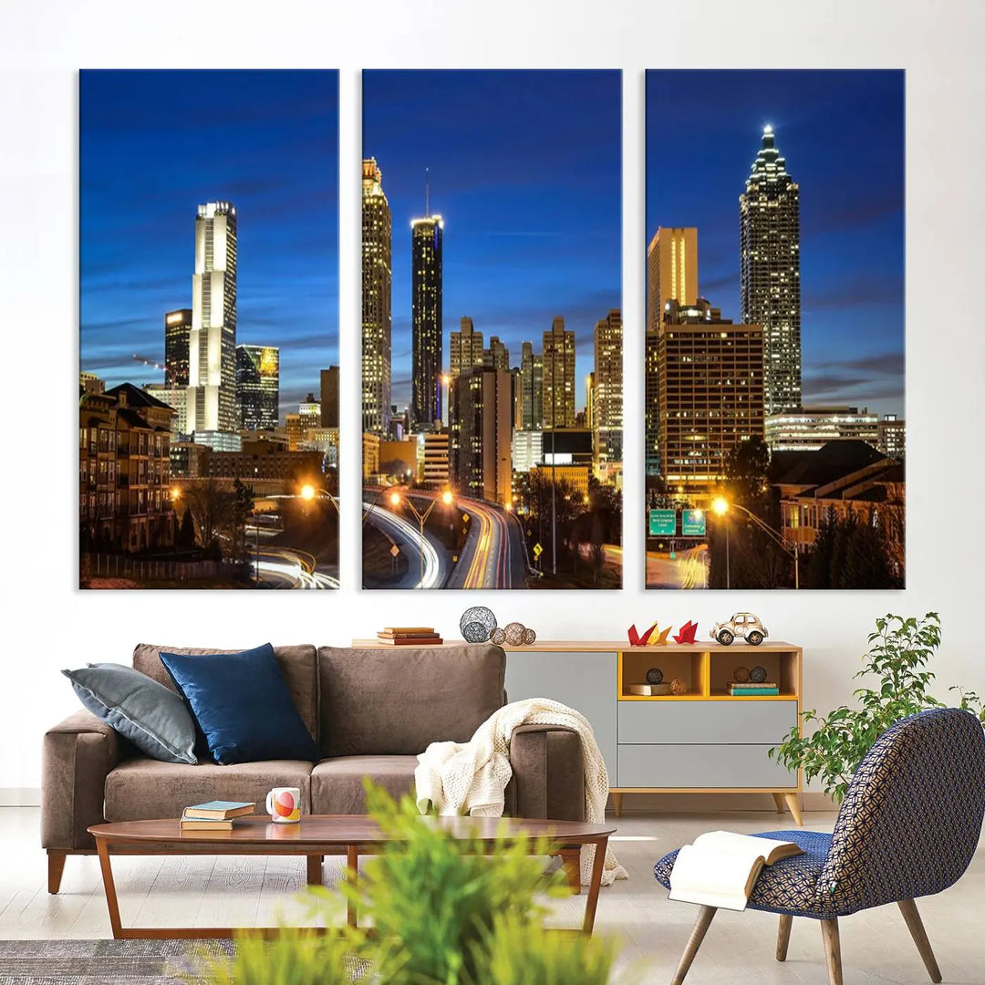 A modern living room is enhanced by the "Atlanta Cityscape View Wall Art Canvas Print" displayed as a triptych on museum-quality canvas. The hand-assembled framed art adds sophistication, crafting an inviting atmosphere. Complete your stylish space effortlessly with free shipping.