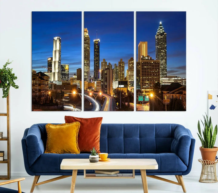 A modern living room is enhanced by the "Atlanta Cityscape View Wall Art Canvas Print" displayed as a triptych on museum-quality canvas. The hand-assembled framed art adds sophistication, crafting an inviting atmosphere. Complete your stylish space effortlessly with free shipping.