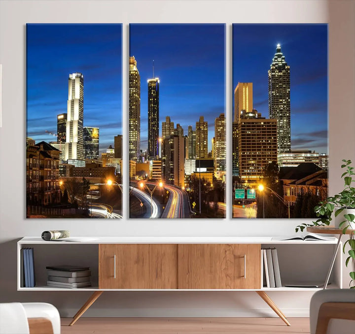 A modern living room is enhanced by the "Atlanta Cityscape View Wall Art Canvas Print" displayed as a triptych on museum-quality canvas. The hand-assembled framed art adds sophistication, crafting an inviting atmosphere. Complete your stylish space effortlessly with free shipping.